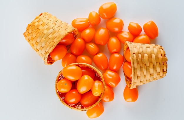 Tomatoes in a wicker baskets. flat lay.