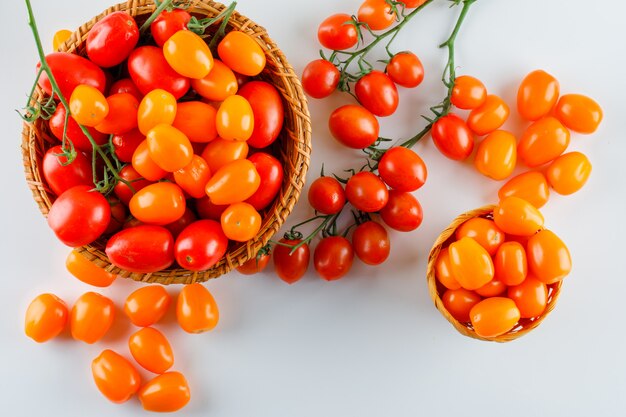 Tomatoes in wicker baskets. flat lay.