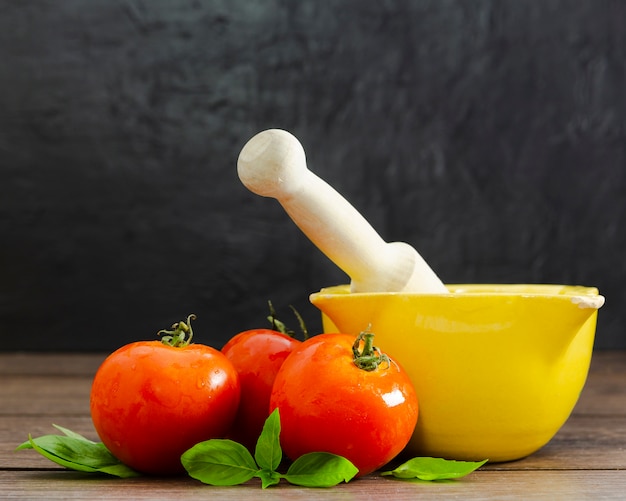 Free photo tomatoes with mint on wooden surface