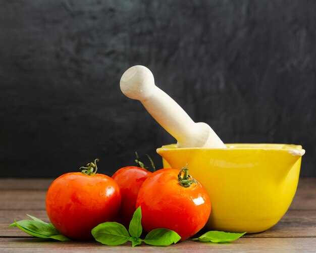 Tomatoes with mint on wooden surface