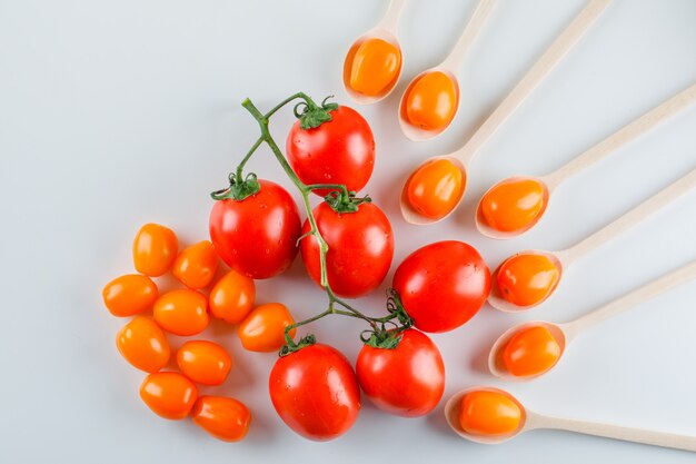 Tomatoes in wooden spoons flat lay