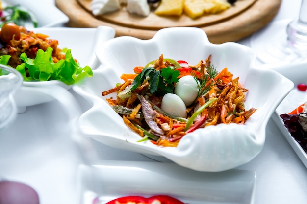 Tongue salad bell pepper crackers cucumber egg side view