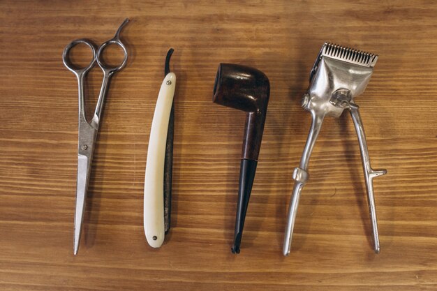 Tools from barbershop on wooden background