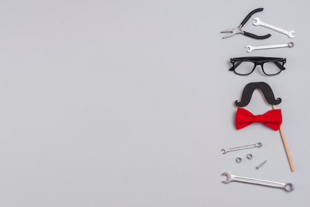 Tools with paper mustache, glasses and bow tie