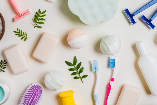 Toothbrush; soap; bath bomb; pink; razor and cosmetics products on white background