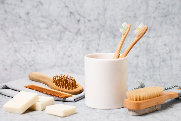 Toothbrushes in cup and natural hair brush