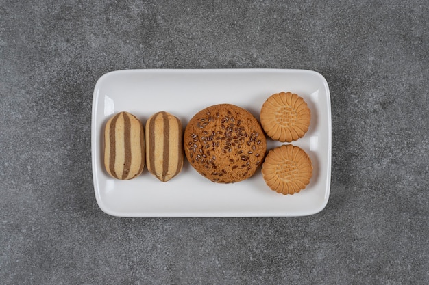 Toothsome biscuits on the plate on the marble surface