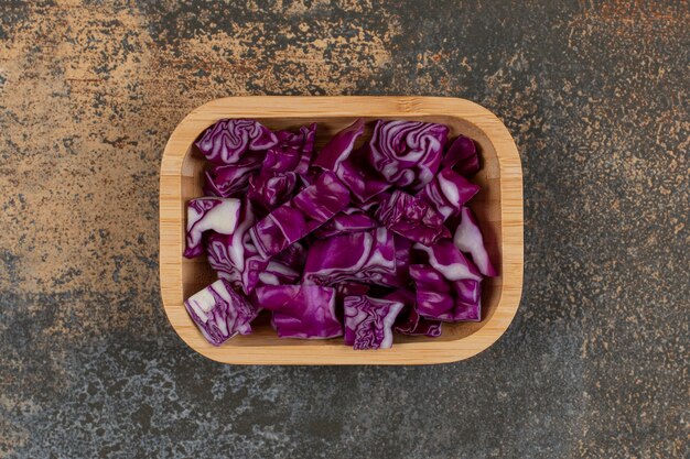 Toothsome red cabbage in the bowl , on the marble surface