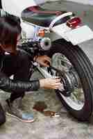 Free photo top angle view of biker repairing his bike