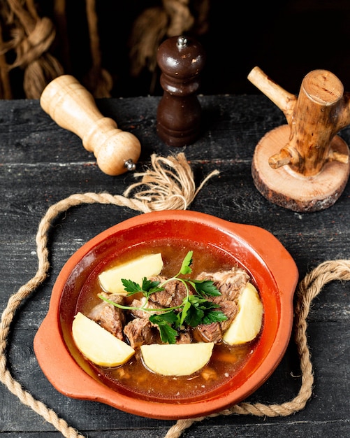 top  beef stew with potatoes in clay stew pot