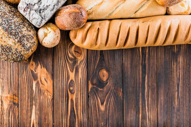 Top border made with freshly breads and baguette on the wooden table