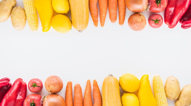 Top and bottom border made with vegetables on white background