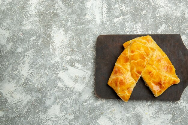 Top close-up view appetizing pies appetizing pies on the kitchen board on the grey table