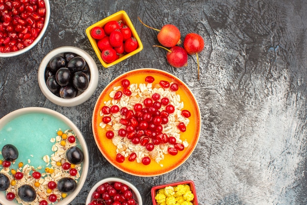 Top close-up view berries the appetizing colorful berries oatmeal seeds of pomegranates