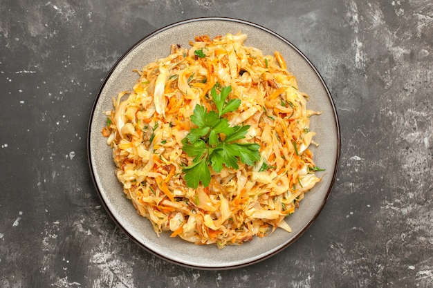 Top close-up view cabbage the appetizing cabbage with carrots and herbs on the grey table