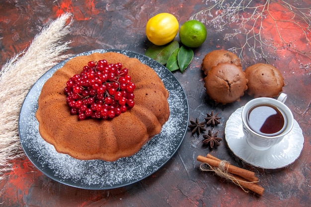 トップクローズアップビューケーキベリーと食欲をそそるケーキお茶の柑橘系の果物のカップ