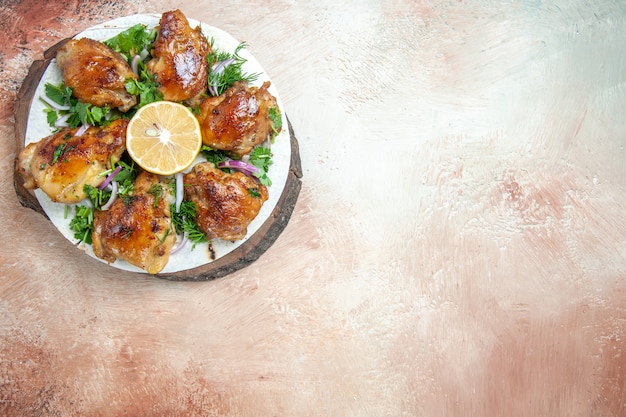 Top close-up view chicken an appetizing chicken with onion lemon herbs on lavash on the board