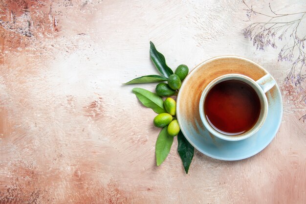 Top close-up view a cup of tea citrus fruits a cup of tea on the saucer