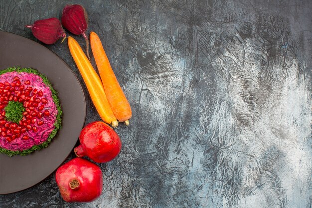 Top close-up view dish an appetizing dish on the plate pomegranates vegetables