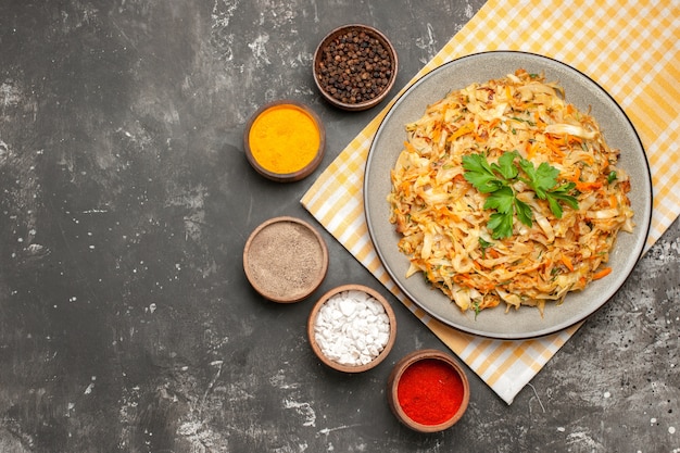 Top close-up view dish dish of cabbage on the tablecloth bowls of colorful spices