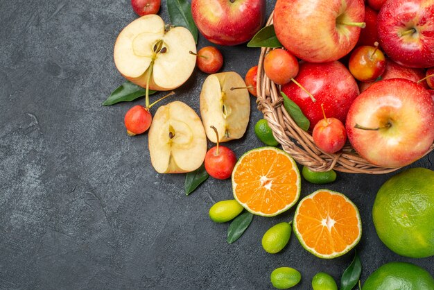 Top close-up view fruits fruits and berries in the basket apples and citrus fruits