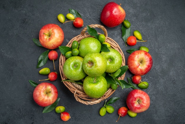 Top close-up view fruits green apples in the basket next to the fruits