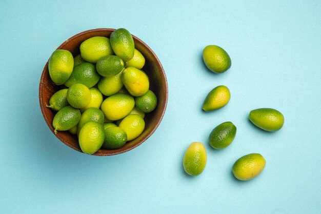 Top close-up view fruits green fruits in bowl next to the fruits