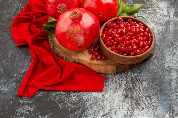 Top close-up view fruits pomegranate seeds pomegranate on the red tablecloth