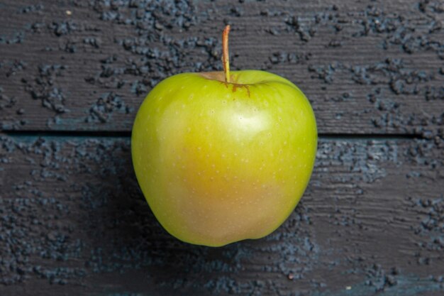 Top close-up view green apple appetizing green apple on wooden dark table