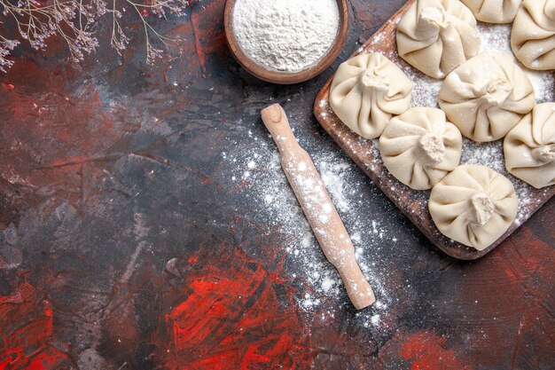 Top close-up view khinkali khinkali on the board flour rolling pin