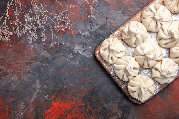 Top close-up view khinkali khinkali flour on the board tree branches