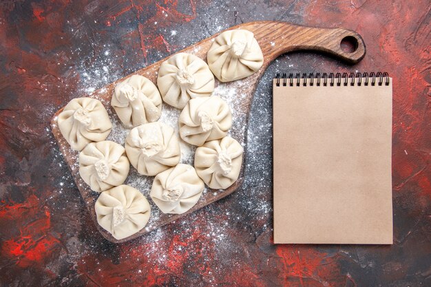 Top close-up view khinkali ten khinkali on the cutting board cream notebook