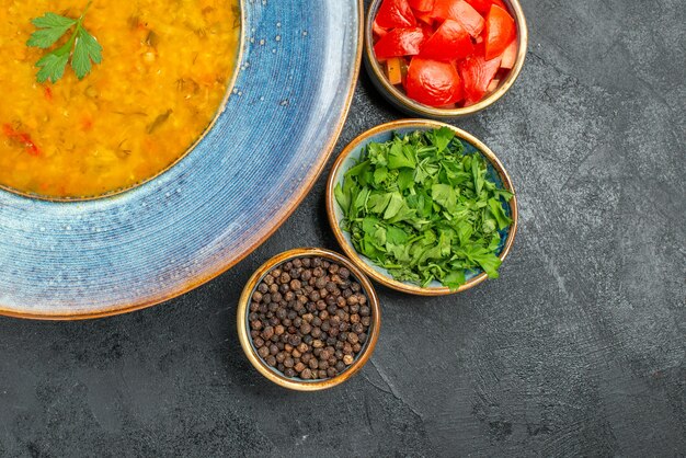 Top close-up view lentil soup bowl of lentil soup tomatoes spices herbs