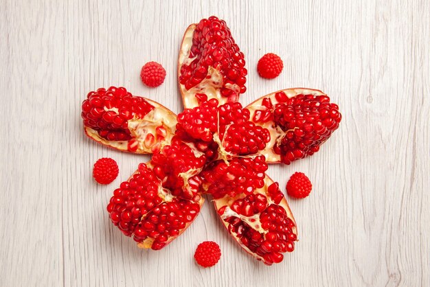 Top close-up view peeled pomegranate appetizing peeled pomegranate next to the berries in the center of the table