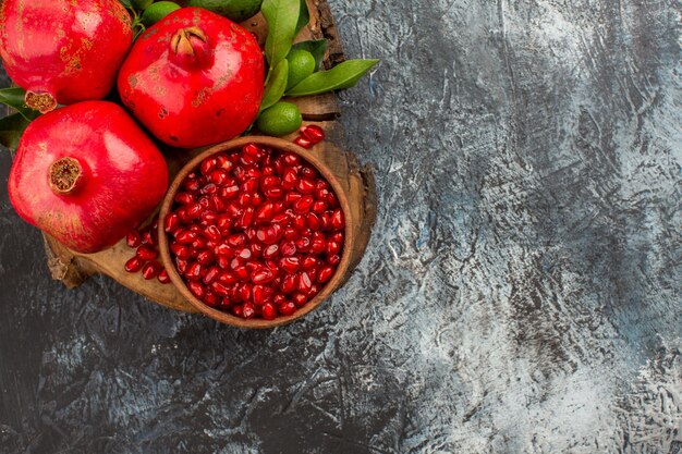 Top close-up view pomegranates seeds of pomegranate in bowl and appetizing pomegranates