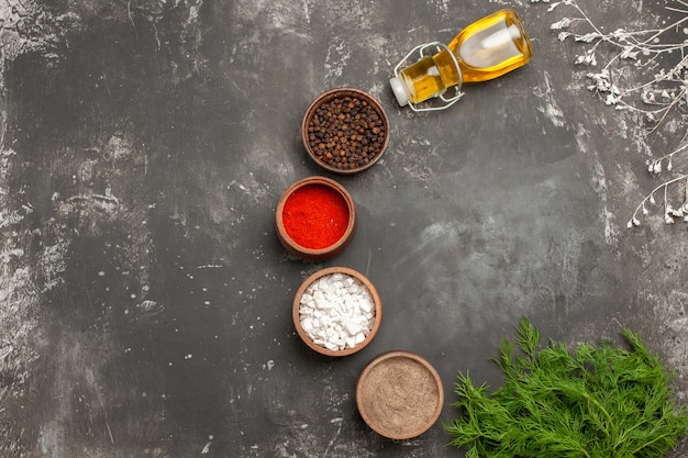 Top close-up view spices bowls of colorful spices herbs bottle of oil