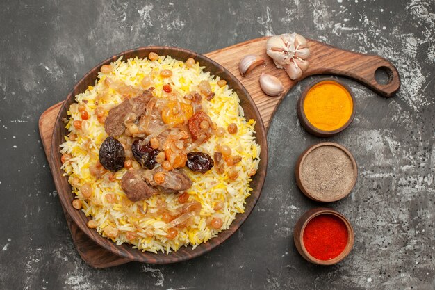 Top close-up view spices colorful spices pilaf on the board garlic