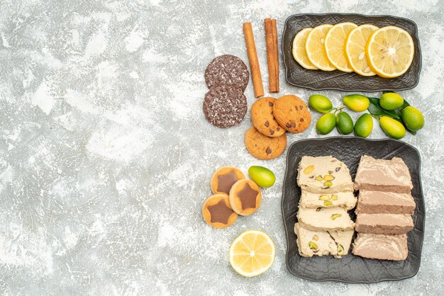 Top close-up view sweets cookies sunflower seed halva citrus fruits cinnamon