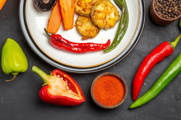 Top close-up view vegetables peppers bowls of spices carrots roasted vegetables