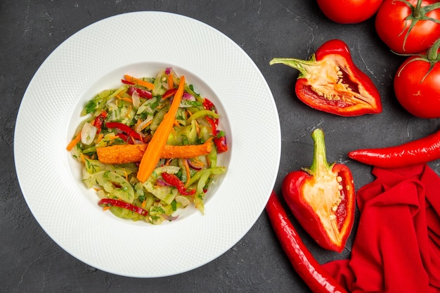 Top close-up view vegetables plate of salad hot peppers bell peppers tomatoes tablecloth