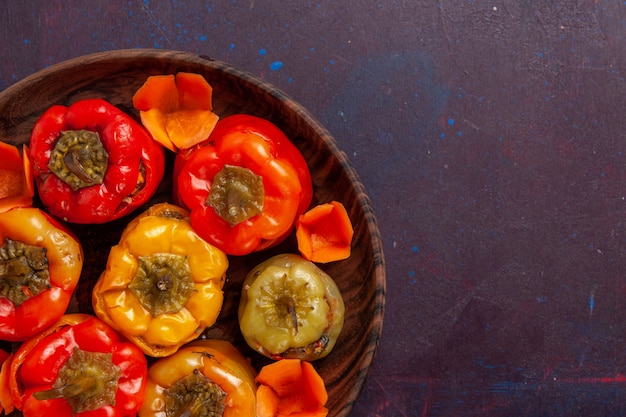 Top close view cooked bell-peppers with ground meat inside on grey background meal vegetables meat dolma food