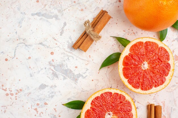 Top close view cut grapefruits fresh grapefruit cinnamon on nude background with free space