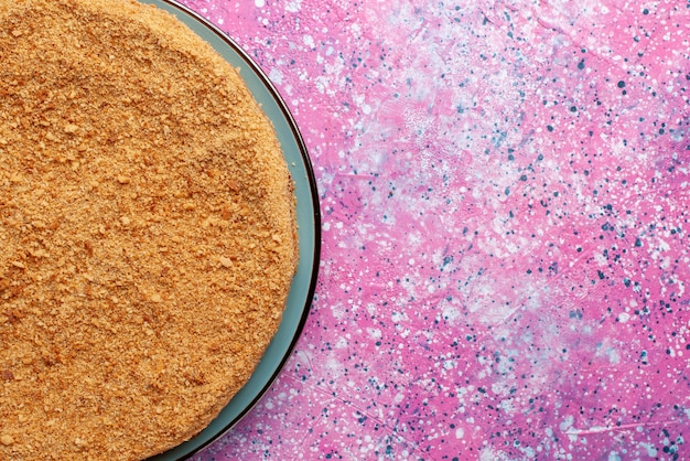 Top close view delicious round cake inside glass plate on the bright desk cake pie biscuit sweet bake sugar