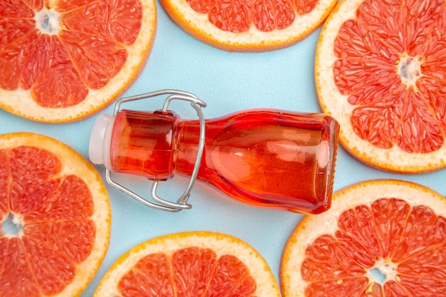 Top close view fresh grapefruits fruit slices on a blue background