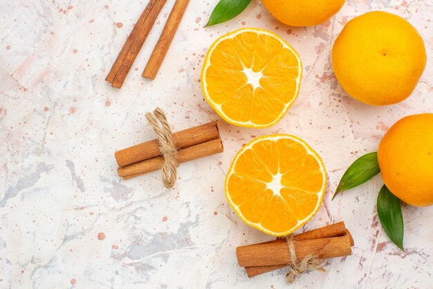 Top close view fresh tangerines cinnamon sticks on bright background