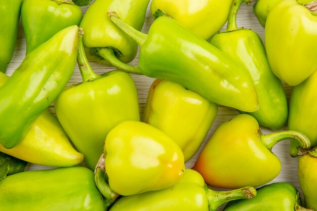 Top close view green bell-peppers on white background color ripe meal plant photo vegetable pepper salad