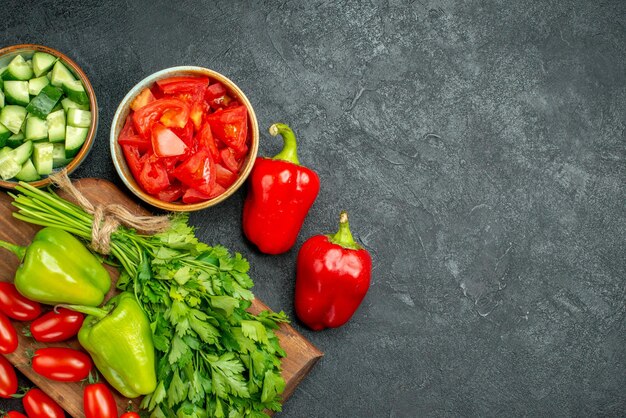 Top close view of plate stand with vegetables on dark grey background