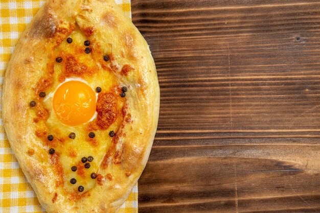 Top close view tasty egg bread fresh off the oven on wooden desk meal bread bun breakfast egg