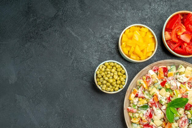 Top close view of vegetable salad with different vegetables on the grey background