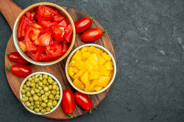 Top close view of vegetables on plate stand on dark grey background